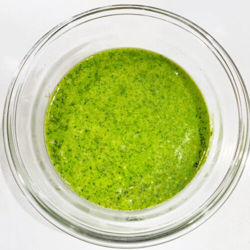fresh basil pesto sauce in glass bowl