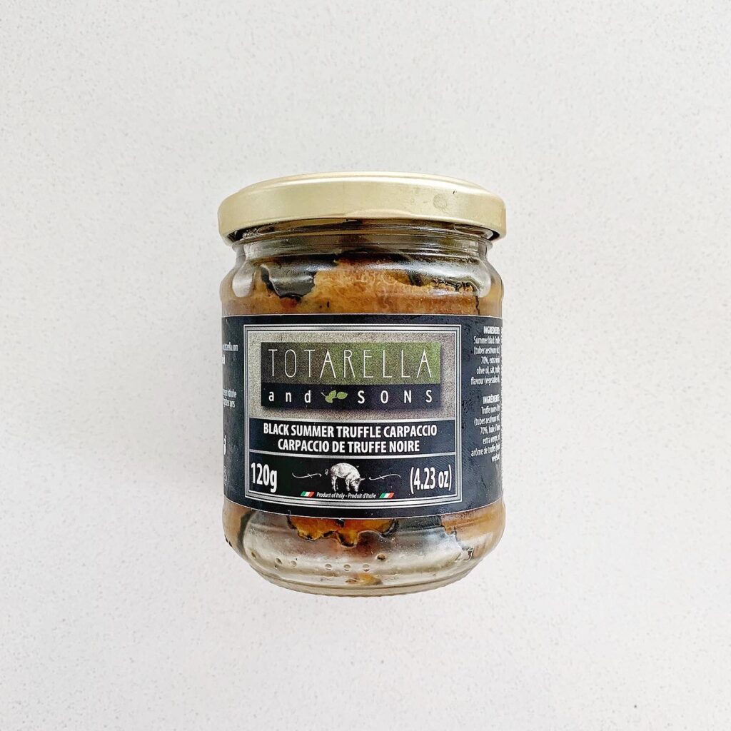 Jar of black truffle carpaccio used for white truffle pizza recipe