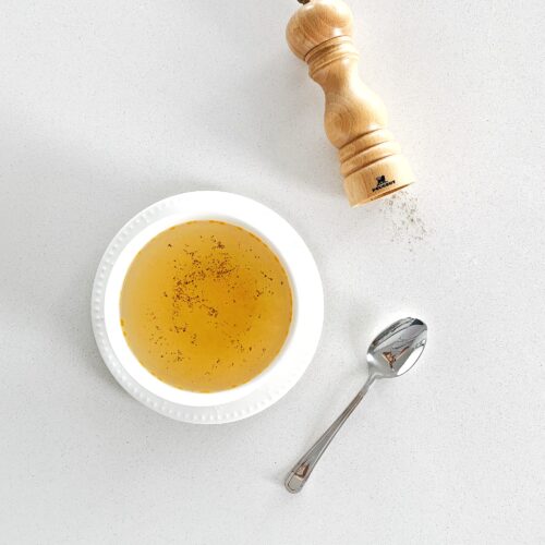 brodino di pollo traditional Italian chicken broth in white bowl