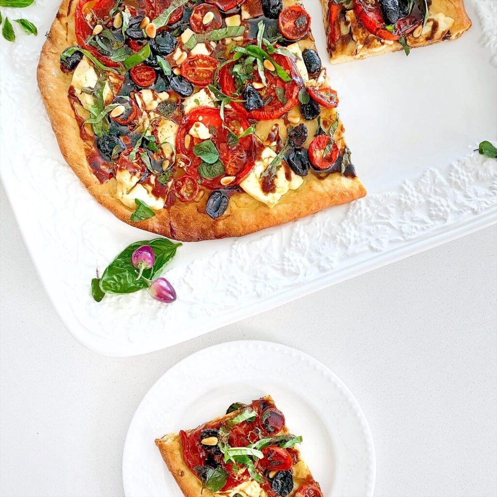 Traditional Spanish coca de recapte Mediterranean flatbread topped with vegetables.