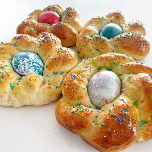 Freshly baked pane di Pasqua Italian Easter bread with colorful eggs and sugar sprinkles