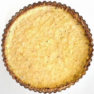 Homemade pumpkin pie with flaky buttery crust and creamy spiced pumpkin filling.