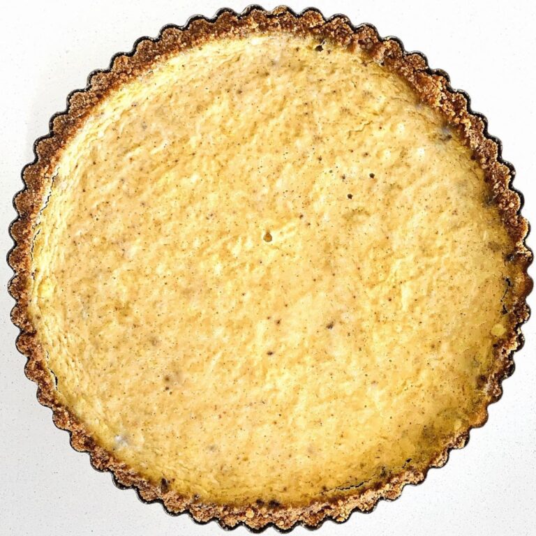 Homemade pumpkin pie with flaky buttery crust and creamy spiced pumpkin filling.