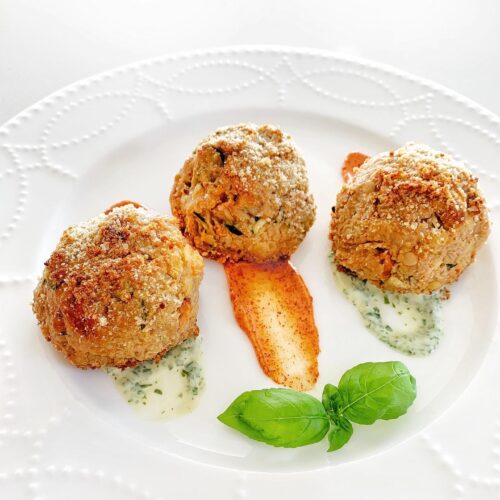 The best veggie ball recipe served crispy and golden with herb sauce and fresh basil