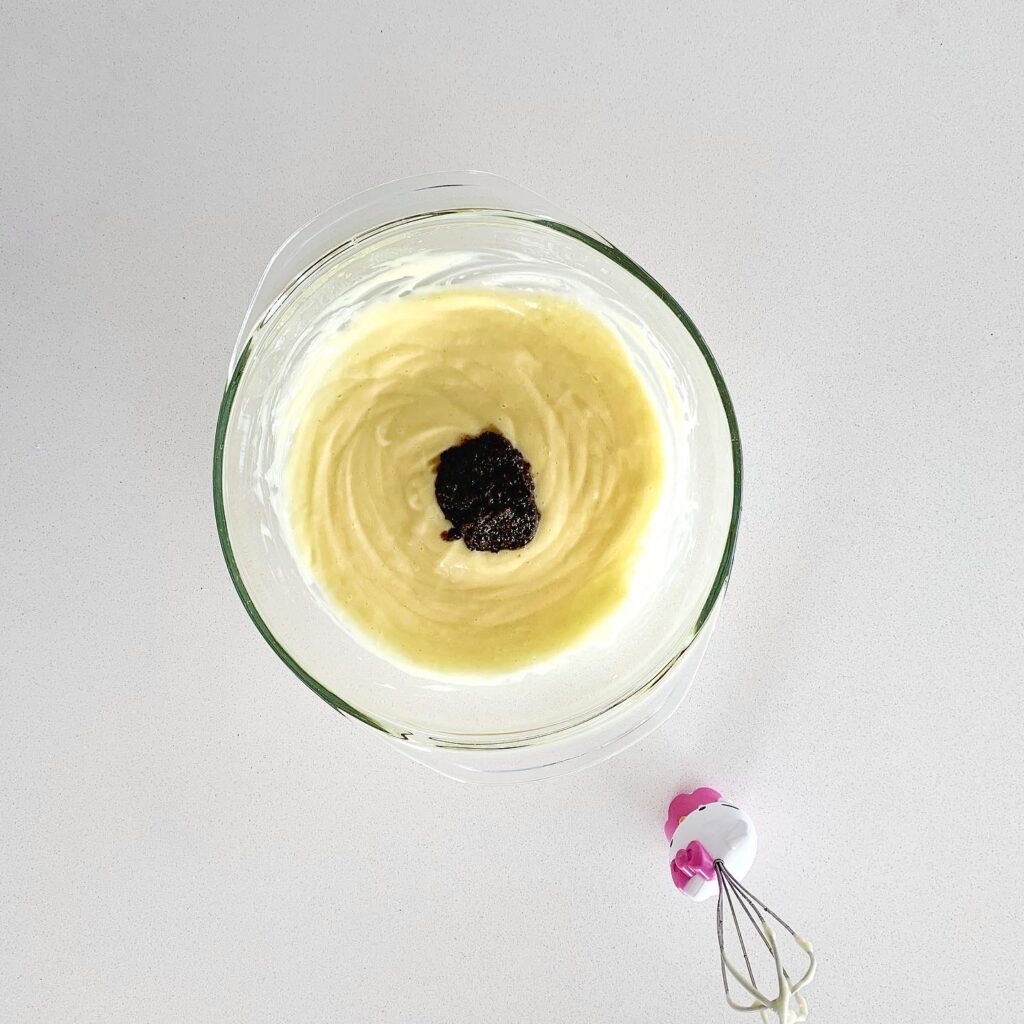 Emulsified aioli mixture thickening into homemade mayonnaise.