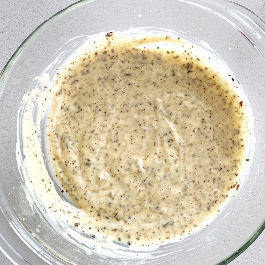 Creamy homemade truffle mayonnaise fully emulsified in a small bowl.