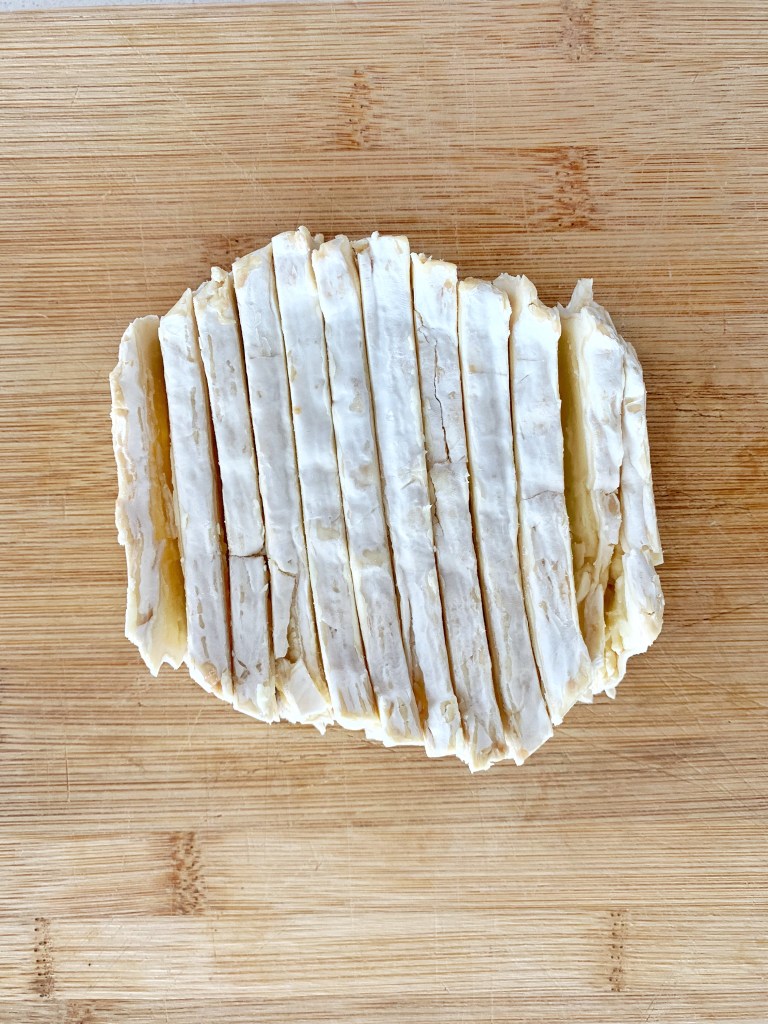 Sliced brie cheese prepared for baked wine tasting appetizers