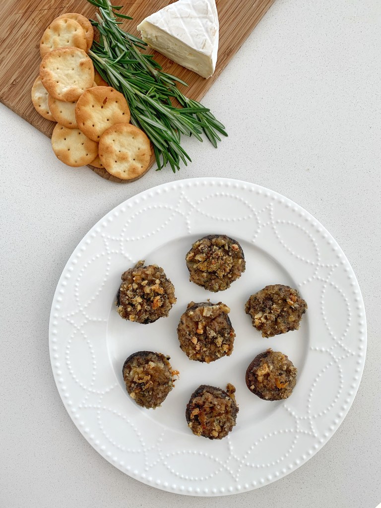 Wine tasting appetizers featuring baked stuffed mushrooms with rosemary and brie
